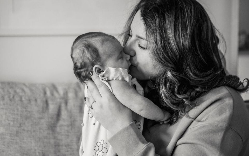 Mother kissing her baby