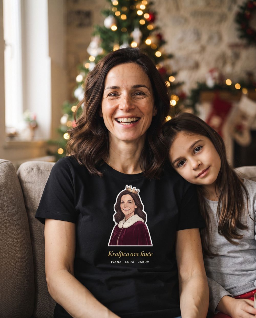 A mother in a black T-shirt with an illustration of her face and a crown